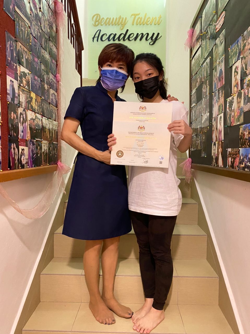 Graduates with their certificates